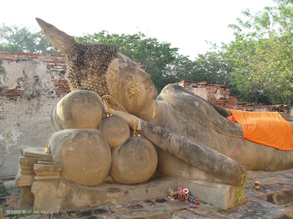 A reclining Buddha image in the ruins of a side chapel