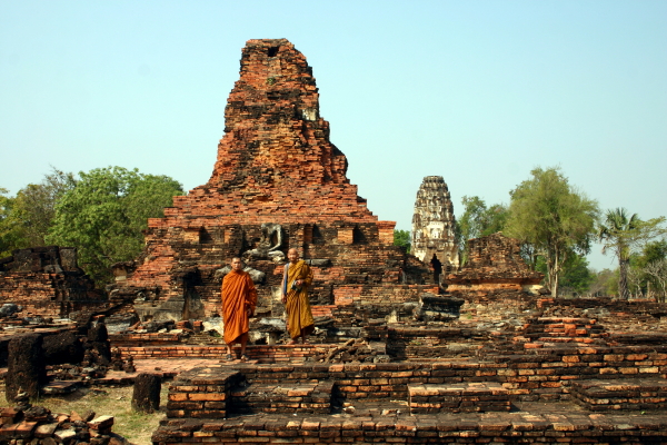 A couple of monks posing in the ruins of Wat Phra Phai Luang