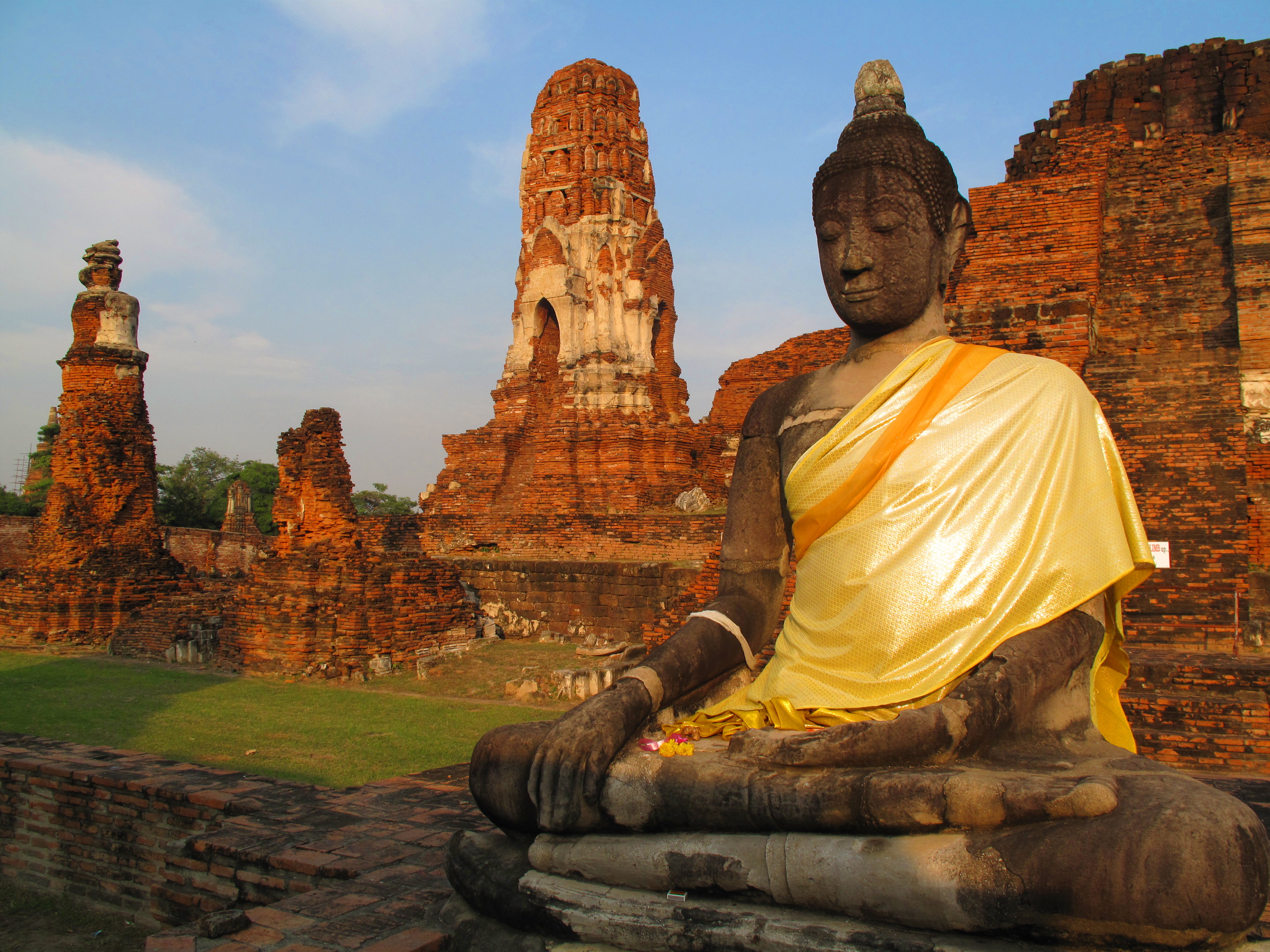 Seated Buddha image with central sanctuary in the background